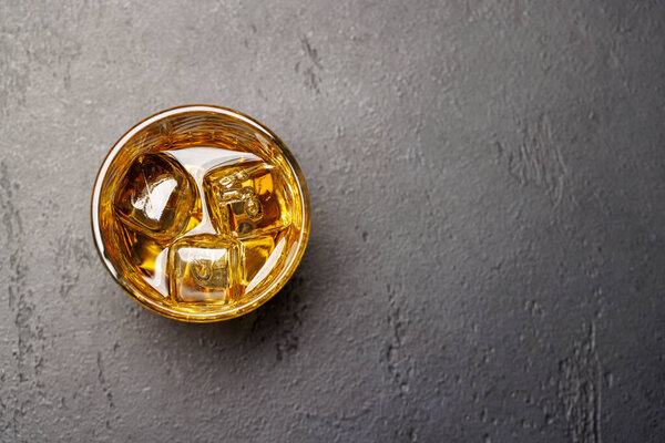 Whiskey with crystal clear ice cubes. With copy space. Flat lay