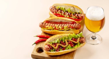 Various hot dog and beer. Homemade hotdogs on cutting board. With copy space