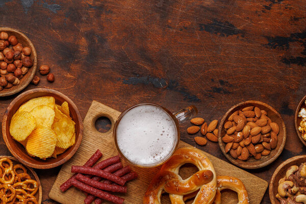 Assorted Beer Stands: chips, nuts, pretzels. Diverse Options for Refreshment flat lay with copy space