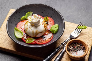 Antipasto with burrata cheese, tomatoes and basil. Italian cuisine