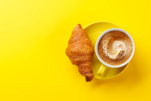 Cappuccino coffee and fresh croissant. Flat lay with copy space