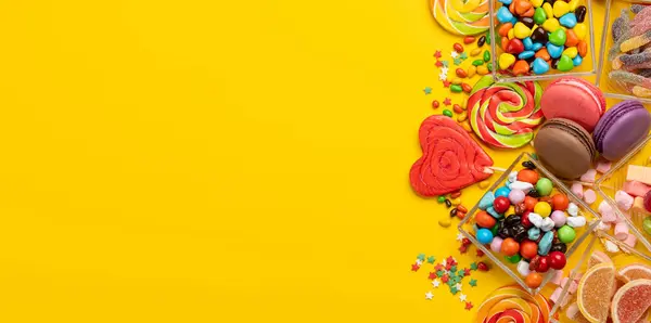 Various Colorful Candies Lollipops Macaroons Flat Lay Sweets Yellow Background Royalty Free Stock Images