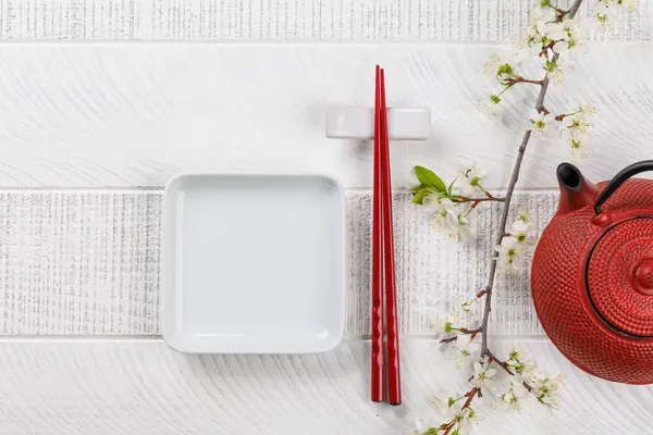 Empty Plate Table Adorned Cherry Blossom Branch Chopsticks Epitomizing Japanese - Stok İmaj