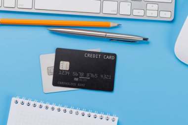 Ofis masasında laptoplu ve malzemeli siyah kredi kartı. Düz yatıyordu. Premium bankacılık kavramı