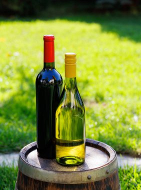 Fotokopi alanı olan fıçı üzerinde şarap şişeleri.