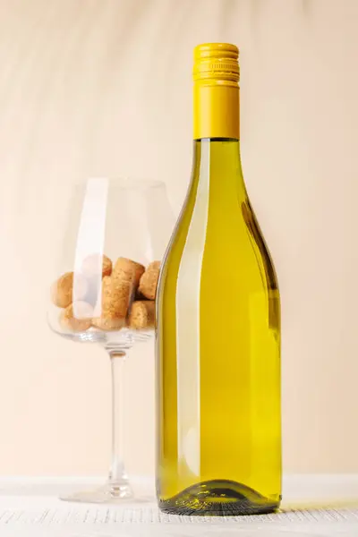 stock image White wine bottle and wine glass with corks. With copy space for your text