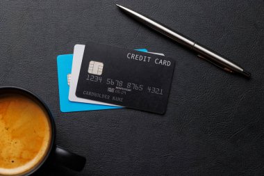 Ofis masasında malzemelerle birlikte siyah kredi kartı. Düz yatıyordu. Premium bankacılık kavramı