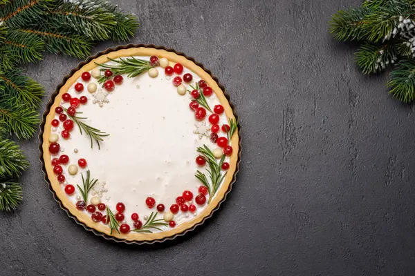 stock image Festive indulgence: Christmas cake adorned with berries and rosemary. Flat lay