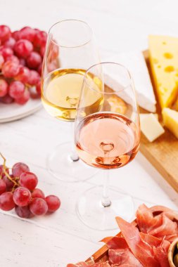 Çeşitli peynirler, taze üzümler, prosciutto ve şaraptan oluşan nefis bir düzenleme gurme yemek deneyimi için zarif bir gösteri yaratıyor. Şarap ve peynir aşıkları için mükemmel.