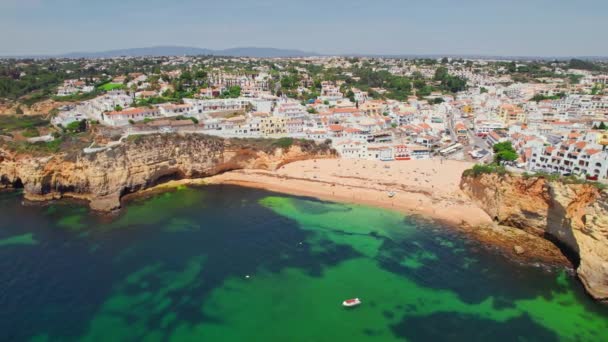 人気のあるカルボエイロの町とポルトガルの美しいビーチとアルガルヴェ海岸の風景 ポルトガルの海沿岸にカラフルな家とカルボエイロビーチの空中ビュー 軌道ショット — ストック動画