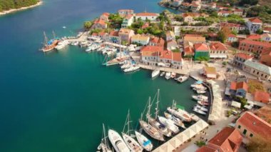 Aerial view of the picturesque Fiskardo village and port Kefalonia island, Greece. Sail boats and yachts moored in traditional fishing village of Fiscardo, Cefalonia, Greece. Drone orbit shot
