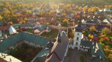 Aerial view of the Stary Sacz town in autumn at sunset, Lesser Poland Voivodeship, Poland. Convent of the Poor Clares, Parish Church of St. Elizabeth and cityscape of Stary Sacz. Fall season in Poland