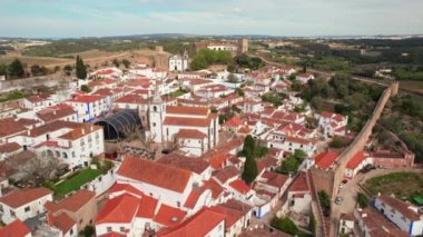 Obidos Medieval Town, Portugal. Aerial view of the historic walled town of Obidos, near Peniche, Portugal. Naroow streets and historic buildings of the Medieval fortress in Obidos.