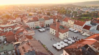 Aerial view of Tarnow old town at sunrise, Poland. Drone footage of the Tarnow cityscape with Cathedral Church of Holy Family, Rynek square with Town Hall and historic buildings at sunny morning.