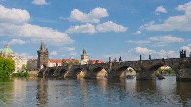 Charles Bridge at sunny day in Prague, Czech Republic. Famous Karlov most bridge over Vltava river in Prague city. Still shot