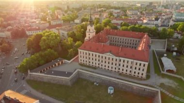Aerial view of the Rzeszow Castle at sunset, Subcarpathian Voivodeship, Poland. Drone footage of Renaissance building of Rzeszow castle with Rzeszow cityscape in summer, Poland. Orbit shot