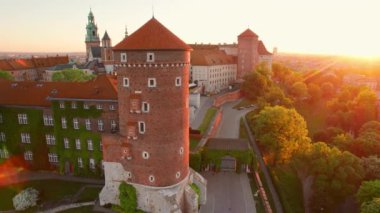 Historic royal Wawel castle in Cracow at sunrise, Poland. Aerial view of the Historical courtyard of the Royal Wawel Castle with Cathedral, Sandomierz Tower and defensive walls in morning light