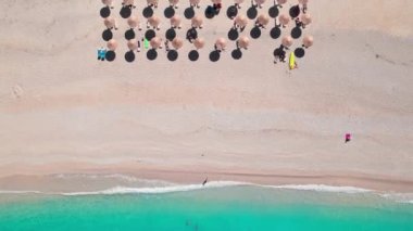 Beautiful Myrtos beach at sunny day on Kefalonia island, Ionian sea, Greece. Top down view of the idyllic white sandy beach with beautiful turquoise sea water. Perfect summer holidays destination 