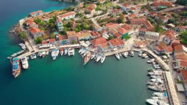 Aerial view of the picturesque Fiskardo village and port Kefalonia island, Greece. Sail boats and yachts moored in traditional fishing village of Fiscardo, Cefalonia, Greece. Drone orbit shot