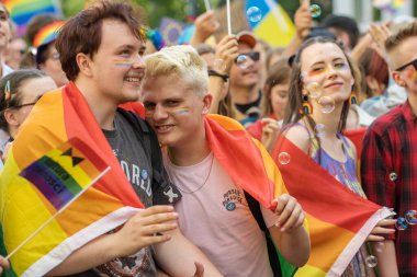 Wroclaw, Poland - June 11, 2022: Unidentified people holding rainbow flag during LGBT pride. Pride community celebrating love and diversity carrying big flag during annual march.