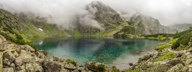 Blake lake in a valley of polish Tatra Mountains is a popular tourist destination in Zakopane, Poland. Panorama of Morskie Oko lake at cloudy day in Tatra National Park.