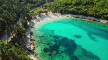 Aerial view of an amazing sea bay with beautiful Emplisi beach near Fiskardo town, Kefalonia island, Ionian sea, Greece. Aerial drone orbit shot. Perfect summer holidays destination