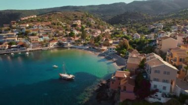 Picturesque Assos town on Kefalonia island, Ionian sea, Greece. Aerial view of the Greek summer resort Assos village, Cephalonia island. Beautiful sea coast of Greece. Orbit shot