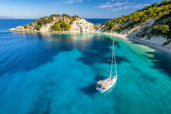 Aerial photo of a moored yacht boat near Gidaki beach with turquoise water in Itaca, Greece. Amazing sea water of the Ithaki island, Kefalonia, Ionian sea.