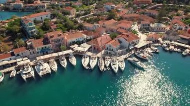 Aerial view of the picturesque Fiskardo village and port Kefalonia island, Greece. Sail boats and yachts moored in traditional fishing village of Fiscardo, Cefalonia, Greece. Drone orbit shot
