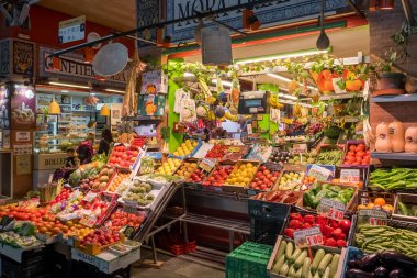 Seville, Spain - April 22, 2022: Fruits and vegetables displayed on the market stall at the traditional indoor Triana Market in Seville, Spain.