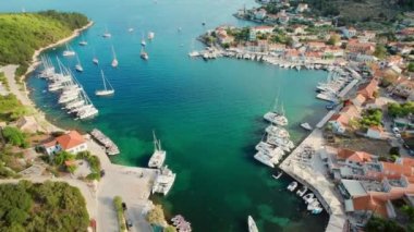 Aerial view of the picturesque Fiskardo village and port Kefalonia island, Greece. Sail boats and yachts moored in traditional fishing village of Fiscardo, Cefalonia, Greece. Drone orbit shot