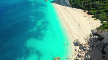 Remote Fteri beach on the Kefalonia island, Ionian sea, Greece. Aerial view of the beautiful coast with white sand beach, high limestone cliffs and amazing turquoise sea water, Cephalonia Greek island