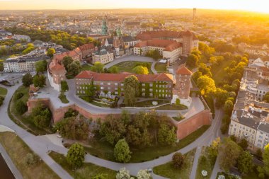 Historic royal Wawel castle in Cracow at sunrise, Poland. Aerial view of the Krakow skyline with Wawel Hill, Cathedral, Royal Wawel Castle, defensive walls. Krakow old town at dawn