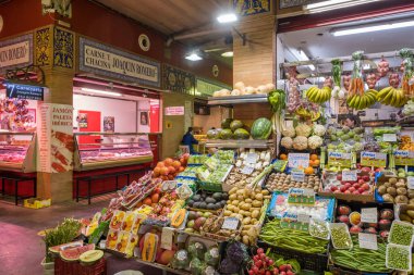 Seville, Spain - April 22, 2022: Fruits and vegetables displayed on the market stall at the traditional indoor Triana Market in Seville, Spain.
