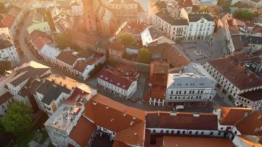 Aerial view of Tarnow old town at sunrise, Poland. Drone footage of the Tarnow cityscape with Cathedral Church of Holy Family, Rynek square with Town Hall and historic buildings at sunny morning.