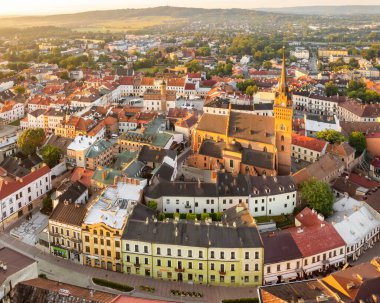 Aerial view of Tarnow old town at sunrise, Poland. Drone photo of the Tarnow cityscape with Cathedral Church of Holy Family, Rynek square with Town Hall and historic buildings at sunny morning.