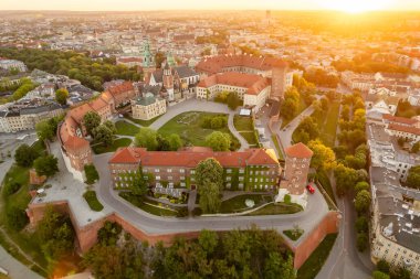 Historic royal Wawel castle in Cracow at sunrise, Poland. Aerial view of the Krakow skyline with Wawel Hill, Cathedral, Royal Wawel Castle, defensive walls. Krakow old town at dawn