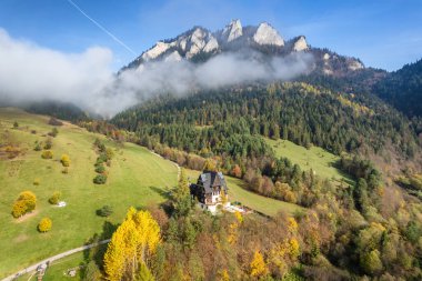 Aerial view of Trzy Korony mountain in Pieniny in autumn, Poland. Beautiful peak Three Crowns during beautiful fall day with orange trees and mountain river on the Slovakia - Poland border clipart