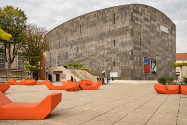 Vienna, Austria - October 12, 2022: Museums Quartier square with people and modern art museum MUMOK in Vienna, Austria