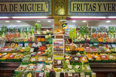 Seville, Spain - April 22, 2022: Fruits and vegetables displayed on the market stall at the traditional indoor Triana Market in Seville, Spain.