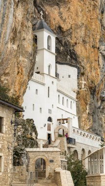 Ostrog monastery in Montenegro. Church of the Holy Cross in rock. Ostrog ortodox monastery in morning fog. Ostrog monastery is the most popular pilgrimage place in Montenegro.