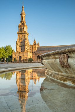 İspanya, Seville 'de gün doğumunda Espana Meydanı. Sevilla 'daki ünlü İspanyol Meydanı. Tarihi pınarın sakin sularında güzel bir yansıma.