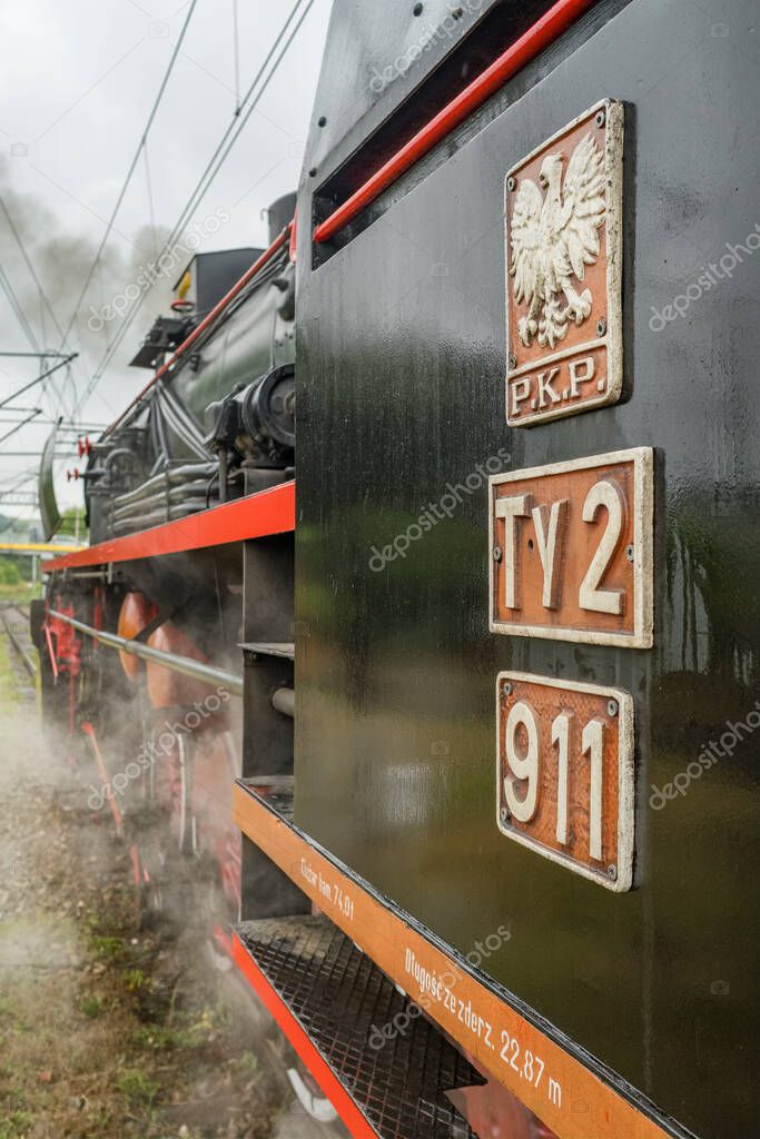 Tarnow, Poland - October 9, 2022: Steam train locomotive close up. Emblem of Polish PKP Polish National Railways on a retro train. Detail of the retro steam train