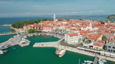 Slovenya 'nın Istria bölgesindeki Adriyatik deniz kıyısındaki Picturesque Izola kasabası. Hava aracı görüntüsü. Küçük marina, ortaçağ binaları ve eski kilise..
