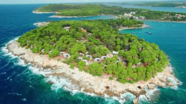 Hırvatistan 'ın Istria bölgesinin Pula kenti yakınlarındaki Adriyatik Denizi' nin kayalık kıyılarında bir kamp alanı bulunan güzel yarımadanın hava manzarası. Aile tatili, Hırvatistan 'da tatil gezisi