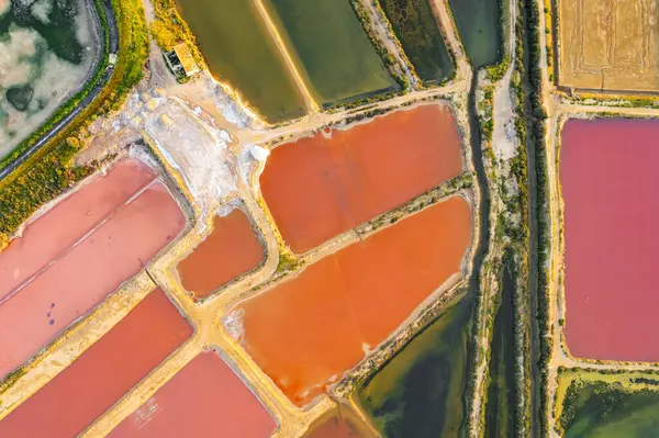 Top down view of the colorful salt ponds near Olhao town, Southern Portugal. Saline marshes on the Ria Formosa lagoon in Tavira, Algarve, Portugal. Salt production in Algarve region