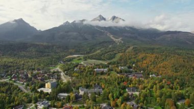 Tatra dağları olan Tatranska Lomnica tatil beldesinin sonbaharda arka planda bulunan insansız hava aracı görüntüsü, Slovakya. Slovakya 'daki High Tatras Ulusal Parkı' nda halk yürüyüşü ve doğa severler