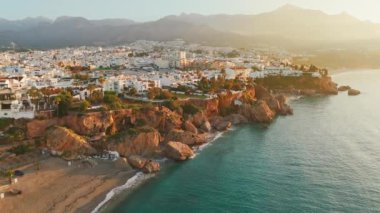 İspanya 'da güneş doğarken, Akdeniz kıyısında Costa del Sol kıyıları inanılmaz. Nerja, Endülüs, İspanya 'daki Playa Carabeo plajının hava manzarası. Lüks villalar, otel tesisi kompleksi ve güzel plaj.