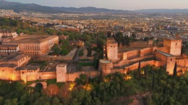 Granada, Endülüs, İspanya 'daki tarihi Alhambra sarayının hava manzarası. Alacakaranlıktaki eski Arap kalesi Alhambra. Granada şehir manzarasının aydınlatmalı hava aracı görüntüleri.