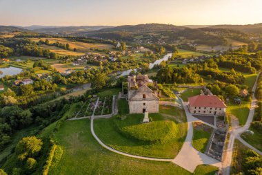 Aerial view of the ruins of the Discalced Carmelite Monastery in Zagorz during sunset in Podkarpackie, Poland. Beautiful landscape of the old monastery in Southern Poland clipart